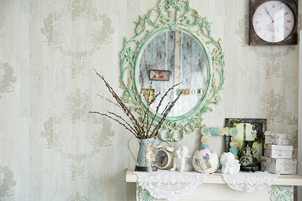 Vintage interior with mirror and a table with a vase and willows