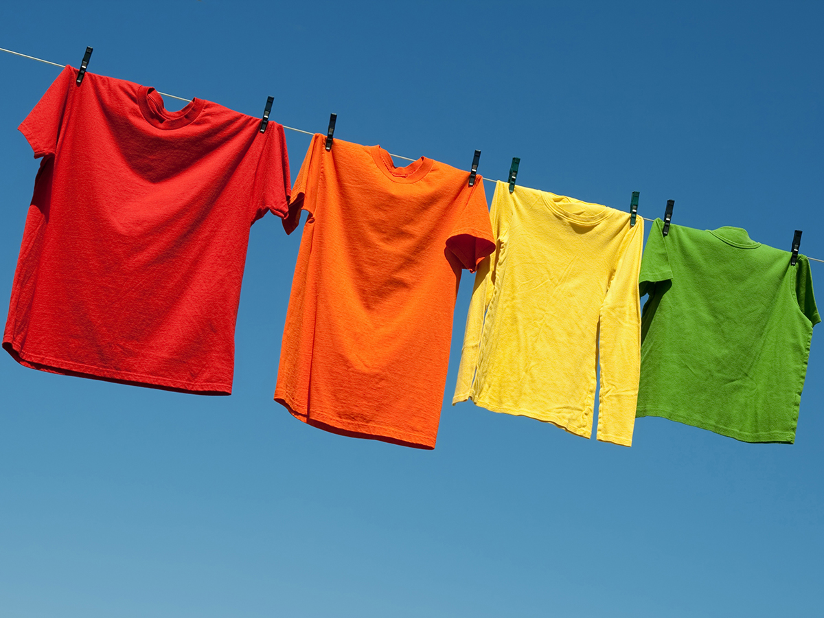 Colorful t-shirts on a laundry line and blue sky