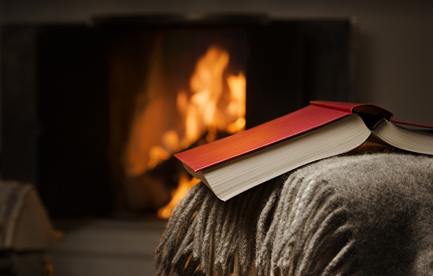 Open book by fireplace.