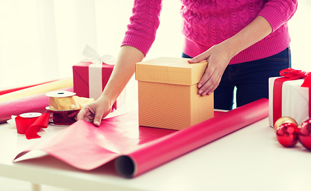 close up of woman decorating christmas presents
