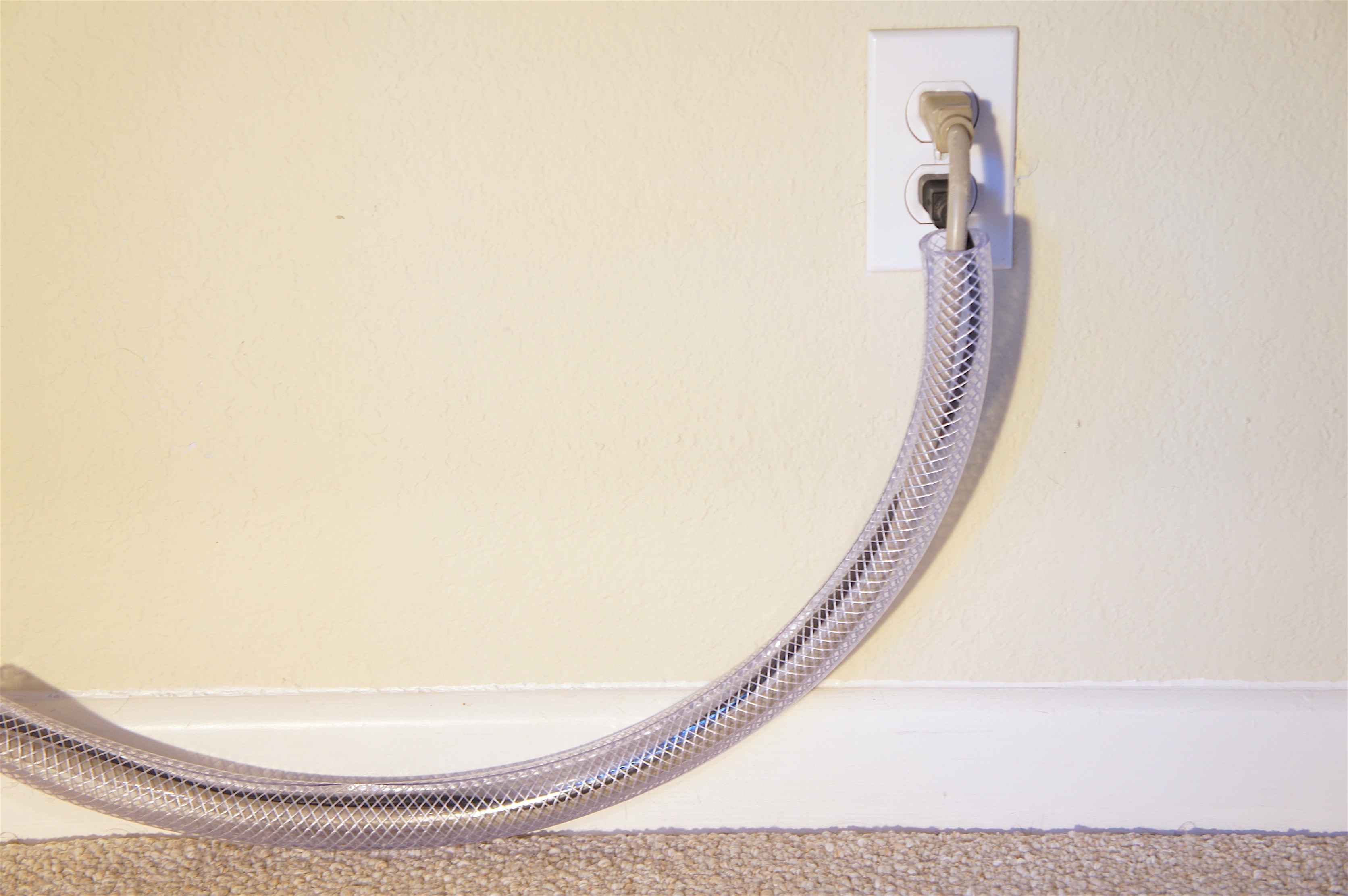 Hide cords in plastic tubing after