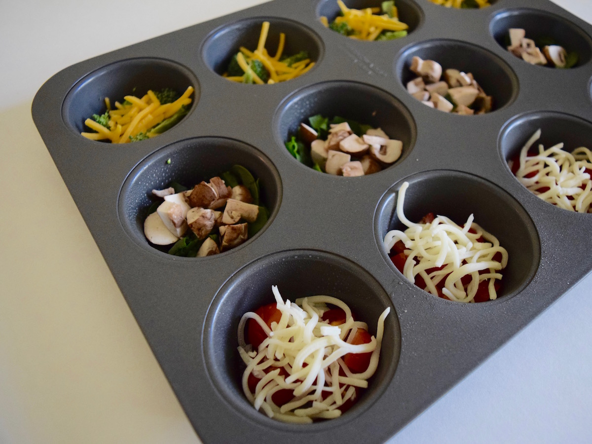 Spray muffin tins with nonstick spray and place a couple of tablespoons of veggies into each muffin cup.