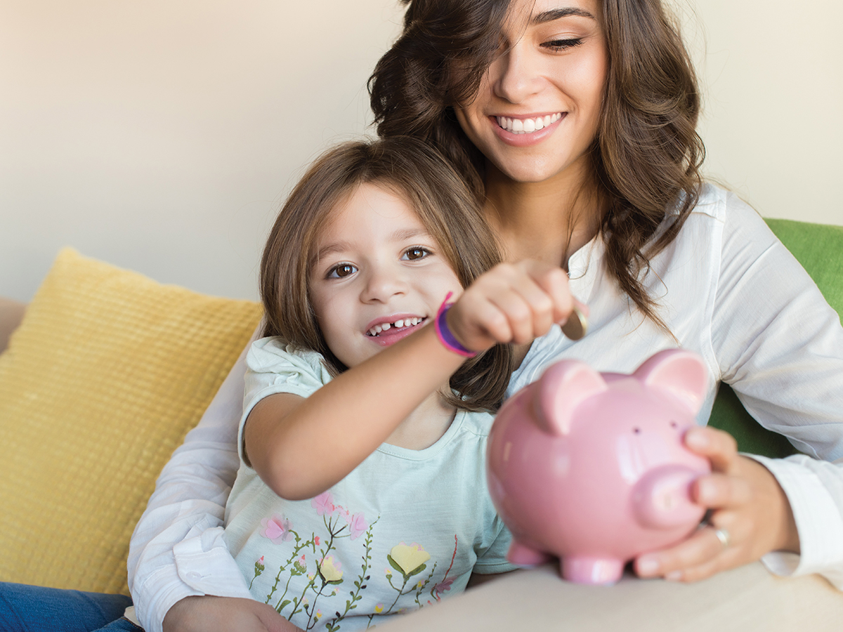 Mom and girl with a piggy bank