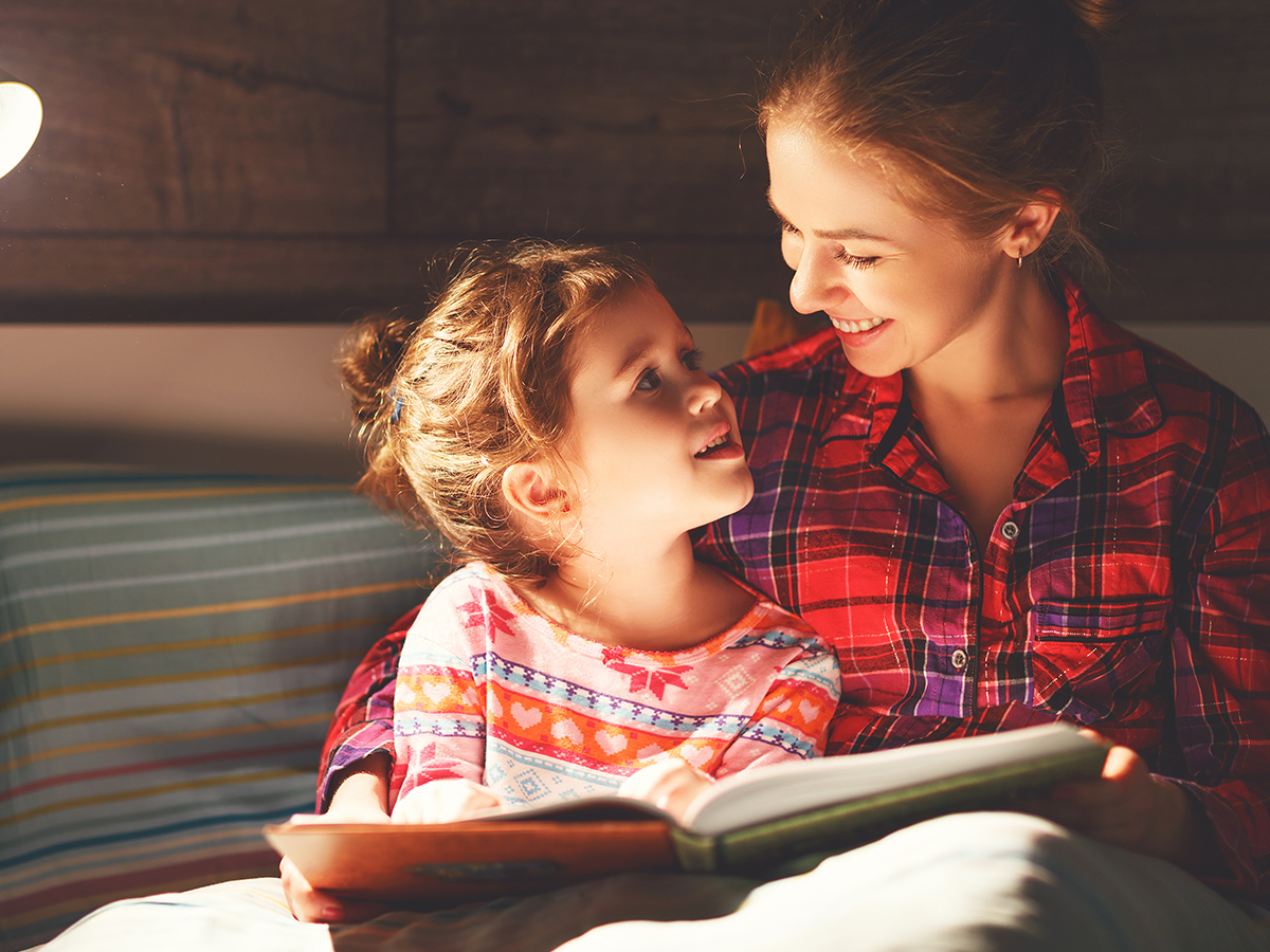 Mother reading her daughter a bedtime story