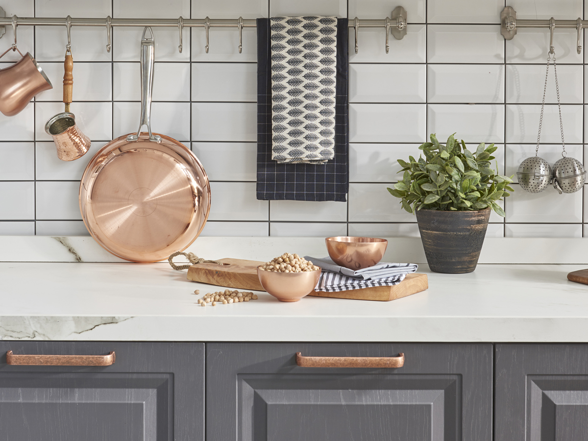 Gray kitchen cabinets with copper accents