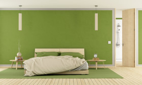 Bed against green wall