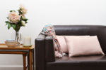 <b>Rose Quartz</b><br>Pull in this soft pink in small doses, like pillows and throws. Pantone’s Rose Quartz instantly lightens darker neutrals and adds subtle sweetness to a room. Plus, it’s easy to find matching <a href=https://blog.rentacenter.com/an-easy-and-beautiful-fall-flower-arrangement/ >florals</a>, which are always a welcome addition to any home.