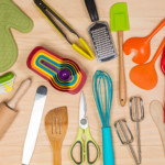 <strong>Kitchen Gear.</strong> A kitchen starter kit is a great way to help out a new grad. Fill a basket with dish towels, an oven mitt, and utensils such as a spatula, slotted spoon, ladle, and measuring cups/spoons.