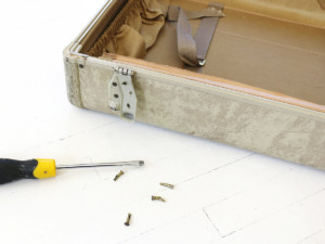 To remove the top, use a screwdriver to force off the hinges from the exterior edge.