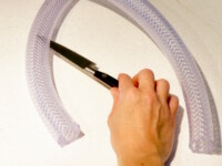 Cut the plastic tubing with a knife.