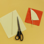 Cut triangle shapes out of construction paper, and insert a skewer into the top and out through the bottom of each paper sail.