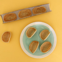 Gently mold cookies into a taco shape and position them in paper towel roll to set.