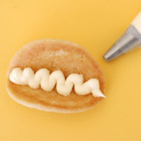 Add frosting to start building your taco cookies.