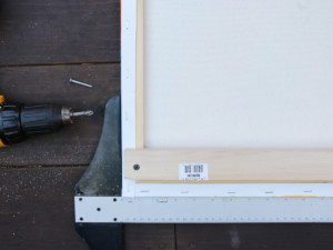 Use a drill and ⅞-inch screws to secure the support to the back of the panels.