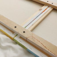 Wrap strong picture wire tightly around the center of the top support.