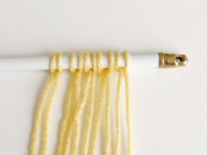 A closeup of the yarn on the rod.