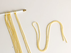 Pull the ends tight to secure the yarn in place. Add as many as desired.