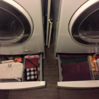 Hide away clutter in drawers under the washer and dryer. Photo: Organized Chaos With a Twist