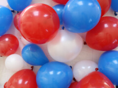 Get your family together to blow up an assortment of red, white, and blue balloons.