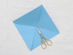 Cut along each crease two-thirds of the way to the center of the paper.