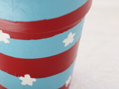 Once the red paint has dried, use a thin paint brush and white paint to add the stars.