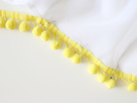 Use pins to help keep the fringe in place alongside the edge of the curtain while measuring.