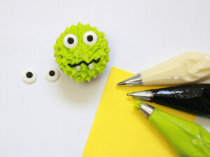 Use candy eyes and frosting to decorate monster Halloween cupcakes.