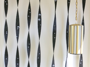 Hang black streamers vertically, taping each piece at the floor and at the ceiling.