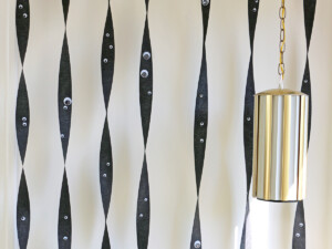 Hang black streamers vertically, taping each piece at the floor and at the ceiling.