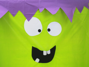 Now use tape to affix the mouth to the tablecloth, and add any additional details you'd like to the face.