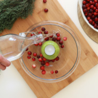 Pouring water in vase with apple tea light
