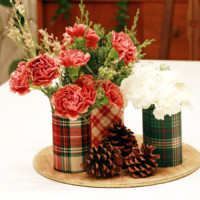 Pinecones next to Tin can vases with flowers