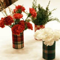 Flowers in decorated tin can vases