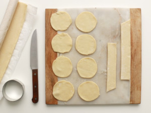 After greasing your cupcake tins, cut a circular piece of puff pastry for the bottom and a rectangular strip for the side.