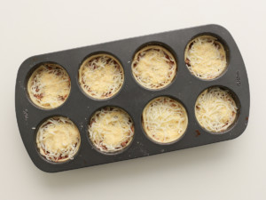 Top each lasagna with a final pinch of mozzarella and Parmesan cheeses.