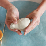 Shape your ball-shaped vase into a slight pear shape by gently molding and rolling it. Shape your ball-shaped vase into a slight pear shape by gently molding and rolling it.