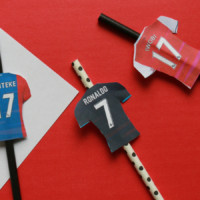 Straws with paper jerseys on them