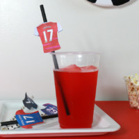 Straw with paper jersey in red drink