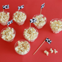 cups of popcorn with soccer ball flags stuck in them