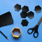Scissors with hexagons cut from paper