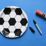 Paper plate with soccer ball pattern drawn on