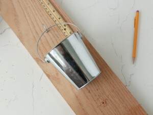 For each container, drill a starter hole using the drill before screwing an eye hook into each hole.
