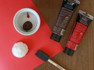 Mix together a small drop of red paint and a large dollop of brown paint.
