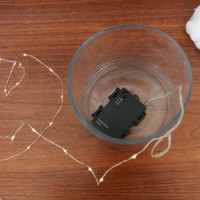 Battery pack for string lights in a vase on a table