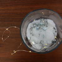 String lights in a vase on a table