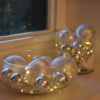 Christmas ornaments and string lights in a bowl