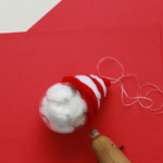 Continue wrapping until you’ve formed a hat shape, then use a dab of hot glue (on a low heat setting) to secure the end of the pipe cleaners to the ornament.