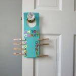 <b>Door Hanger Chore Chart</b><br>
Help your child turn a door hanger into a chore chart with letters that glue or stick on and clothespins labeled with tasks. Give elementary-age kids a set dollar amount for each chore completed. Set up a “payday” at the end of each week. Encourage kids to save for that special item they want.